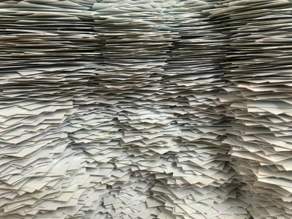 Large stacks of paper fill the photo